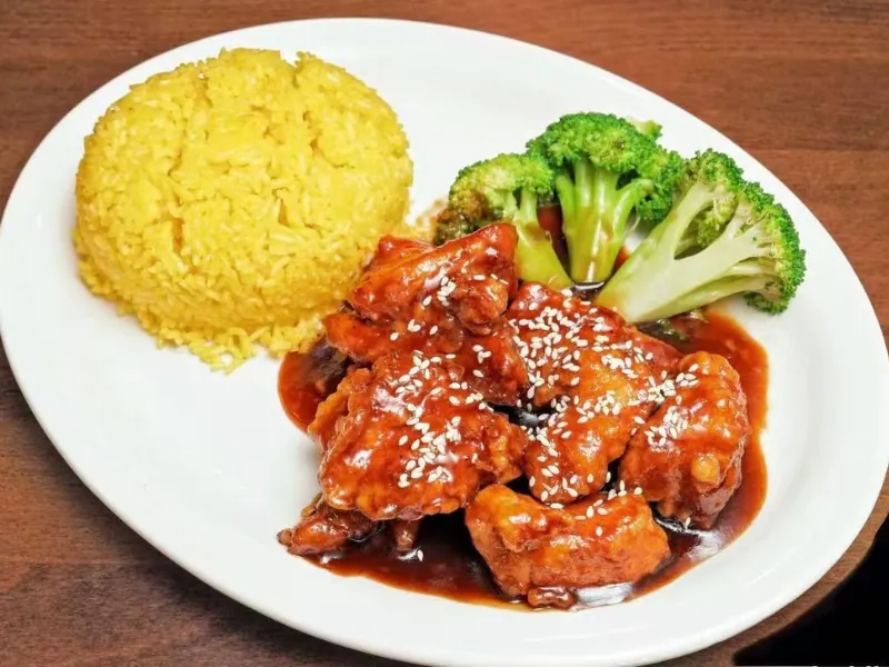 Sesame chicken with rice and broccoli at La Caridad 72, a Asian Restaurant in New York